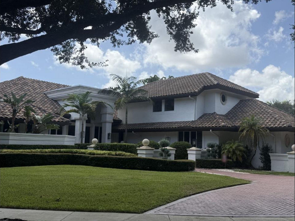 After: Same Boca Raton estate photographed seven months after soft-wash roof treatment — barrel tile remains clean and algae-free