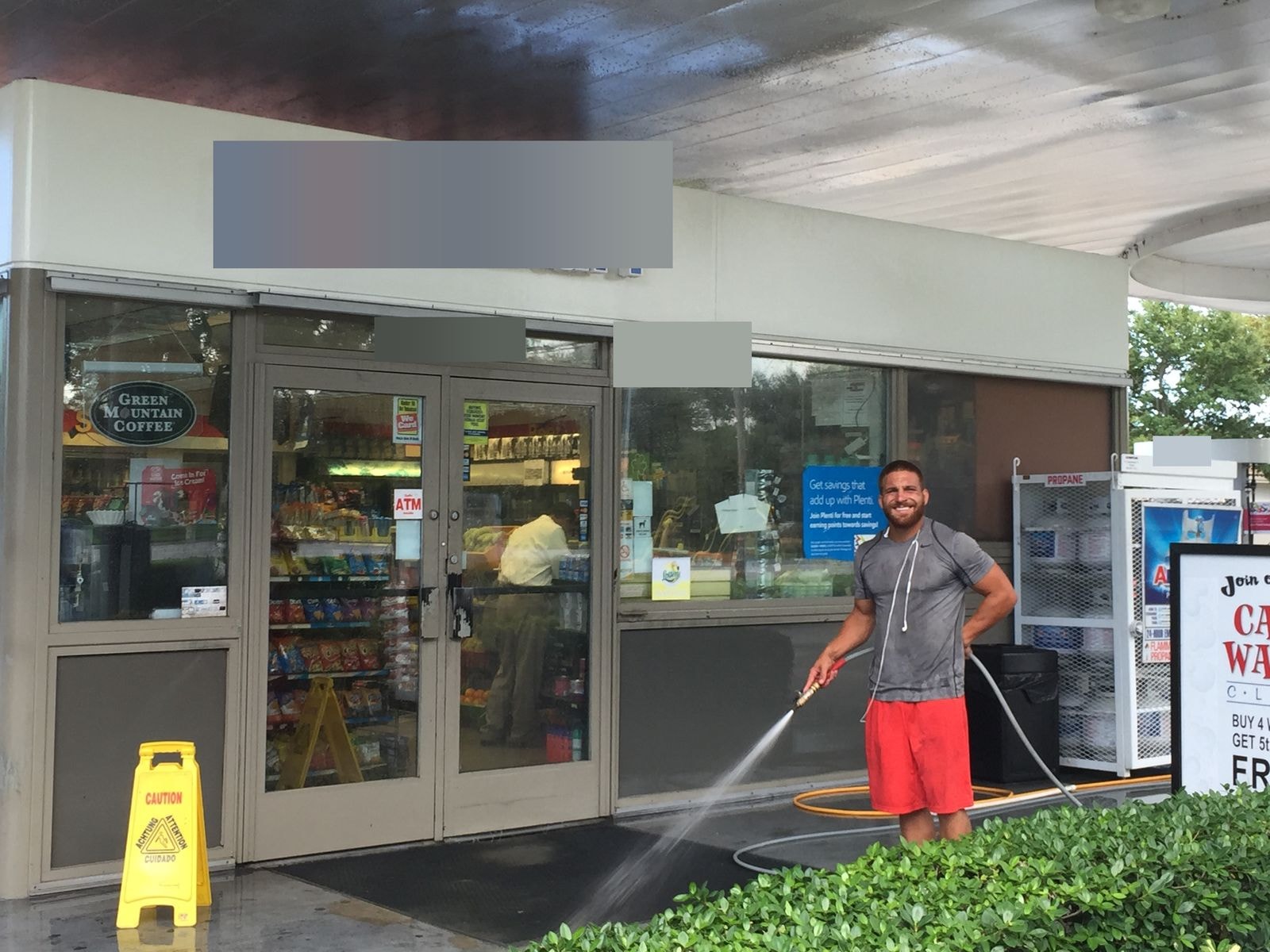 Pressure washing a convenience store entrance and storefront area in Coconut Creek, Florida