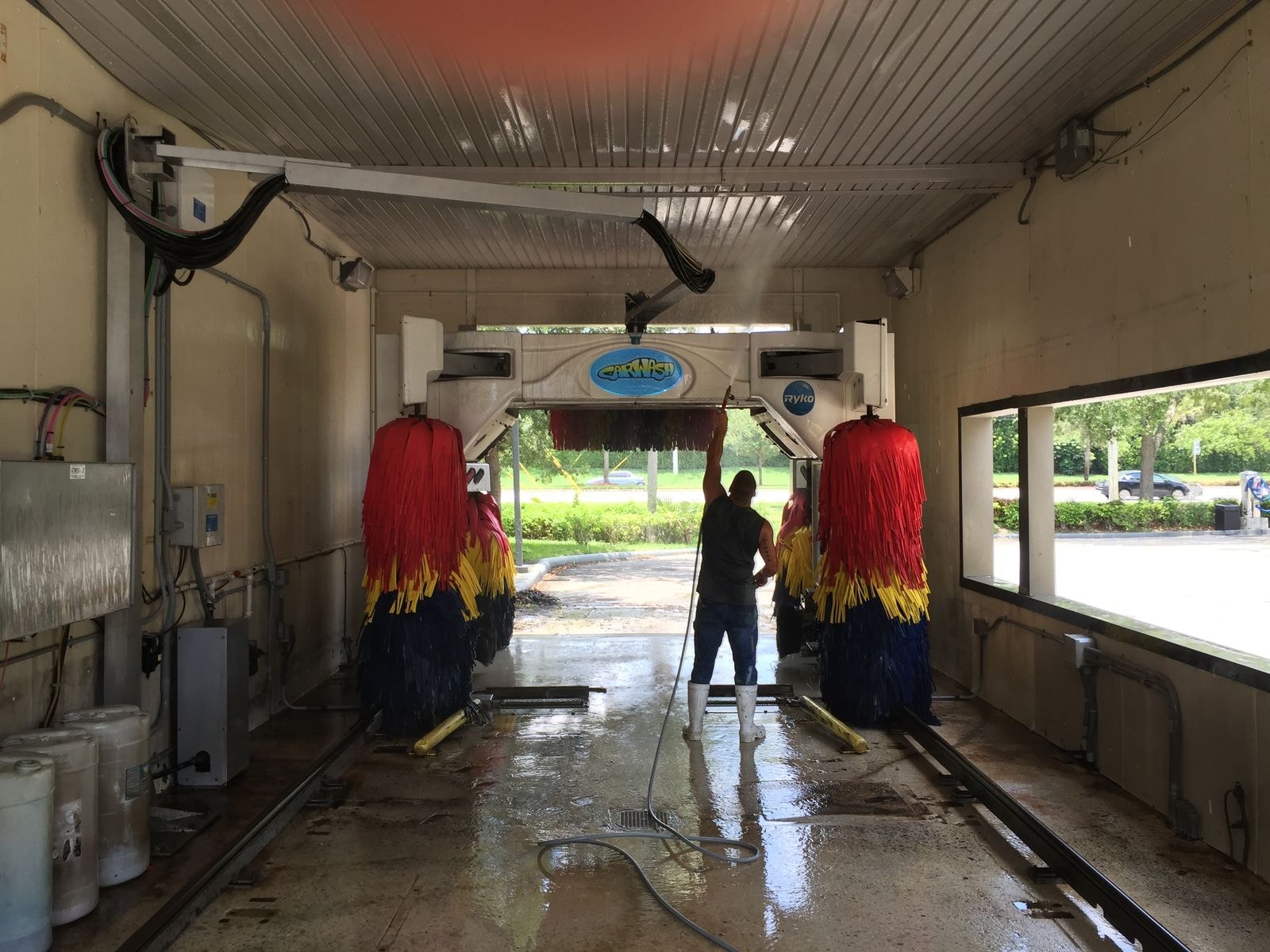 Car wash tunnel being rinsed down during professional cleaning in Coconut Creek, Florida
