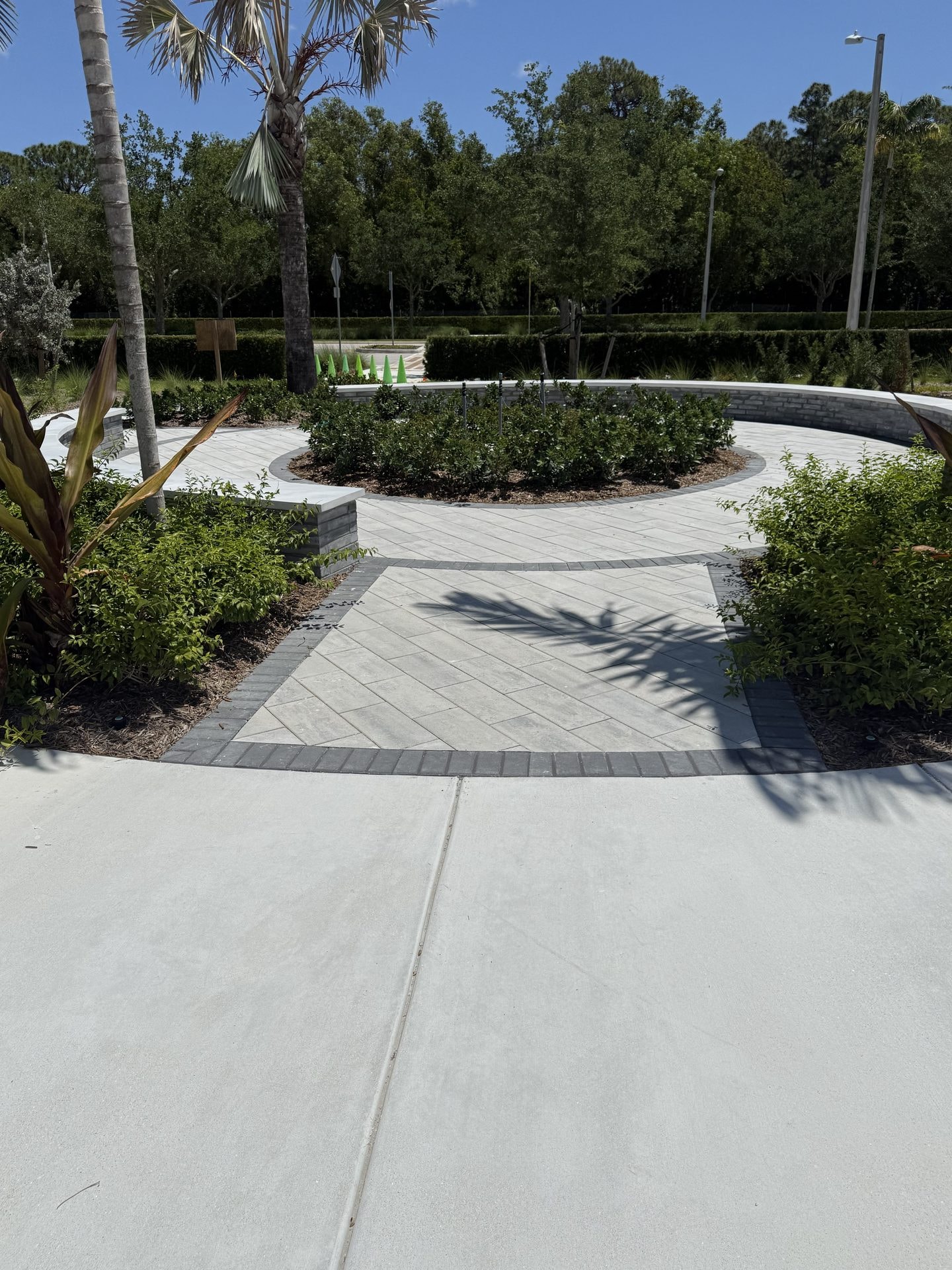 Cleaned concrete courtyard walkway and landscaped island at a medical center, Palm Beach Gardens, FL