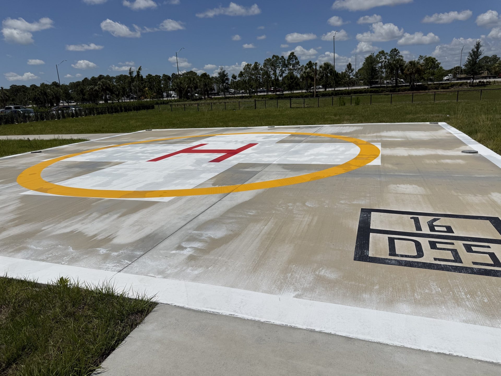Cleaned concrete helipad with painted markings at a medical center, Palm Beach Gardens, FL