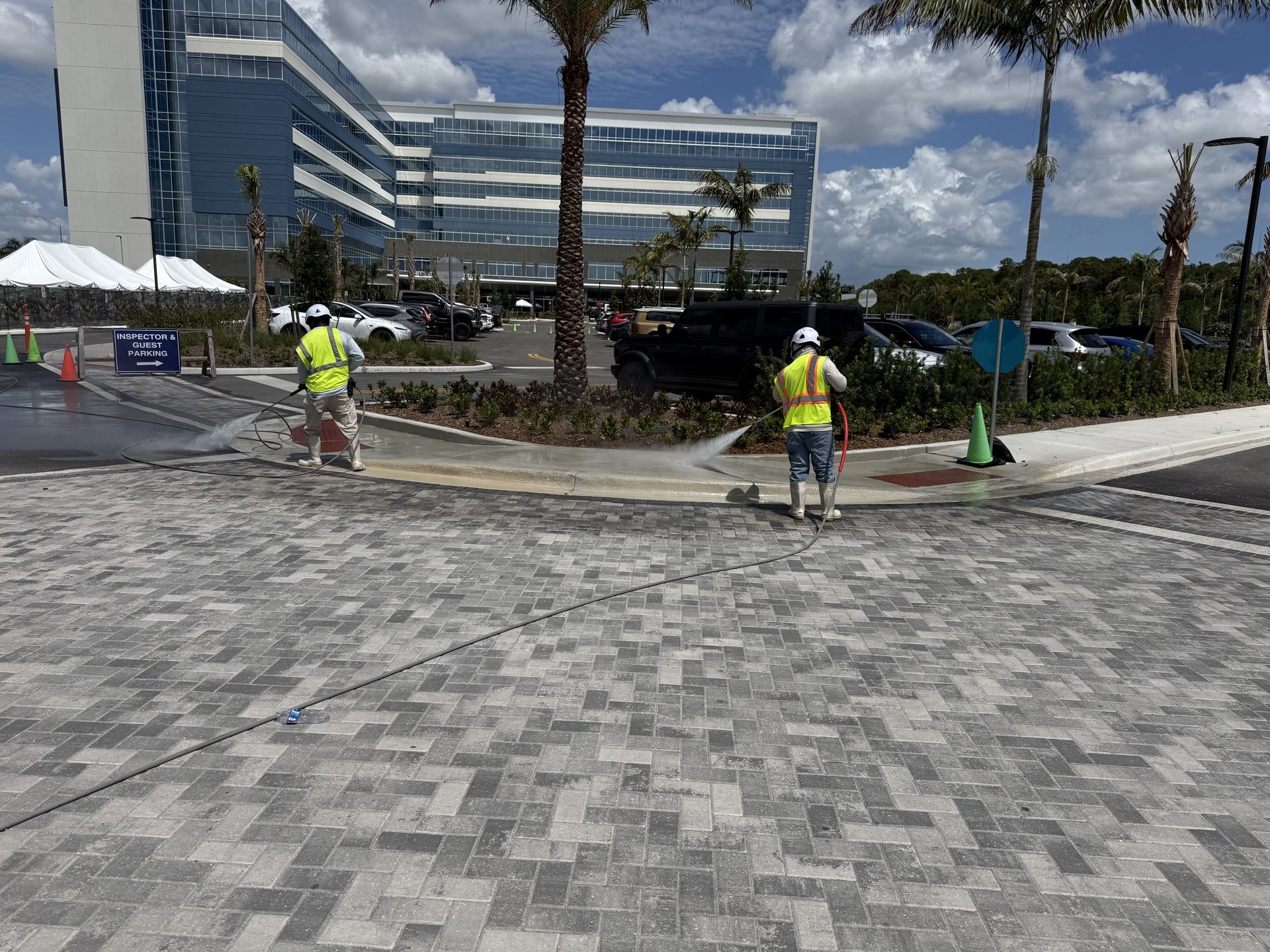 Crew in high visibility vests cleaning paver entry areas at a medical center, Palm Beach Gardens, FL