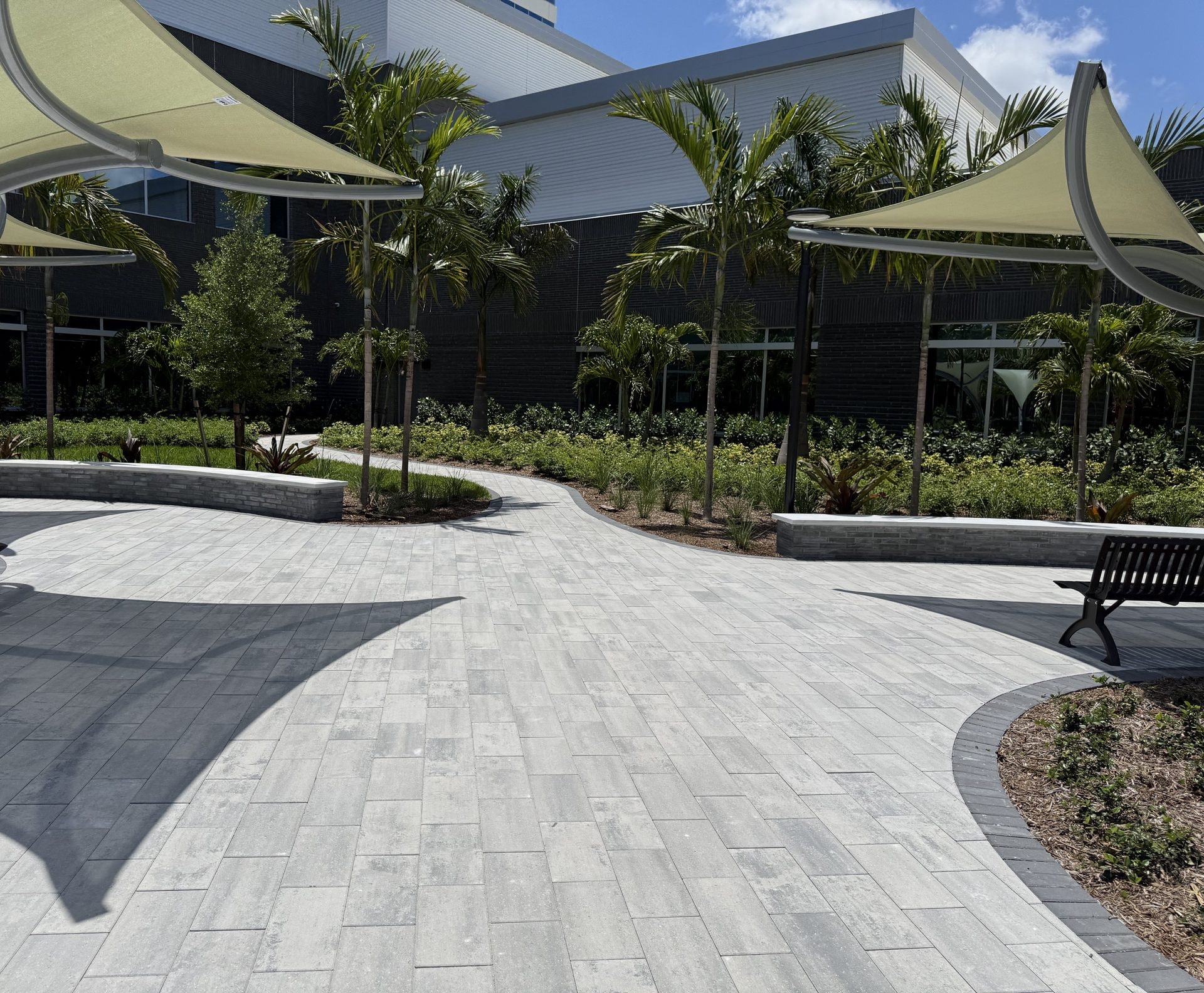 Cleaned paver plaza and walkways beneath shade sails at a medical center, Palm Beach Gardens, FL
