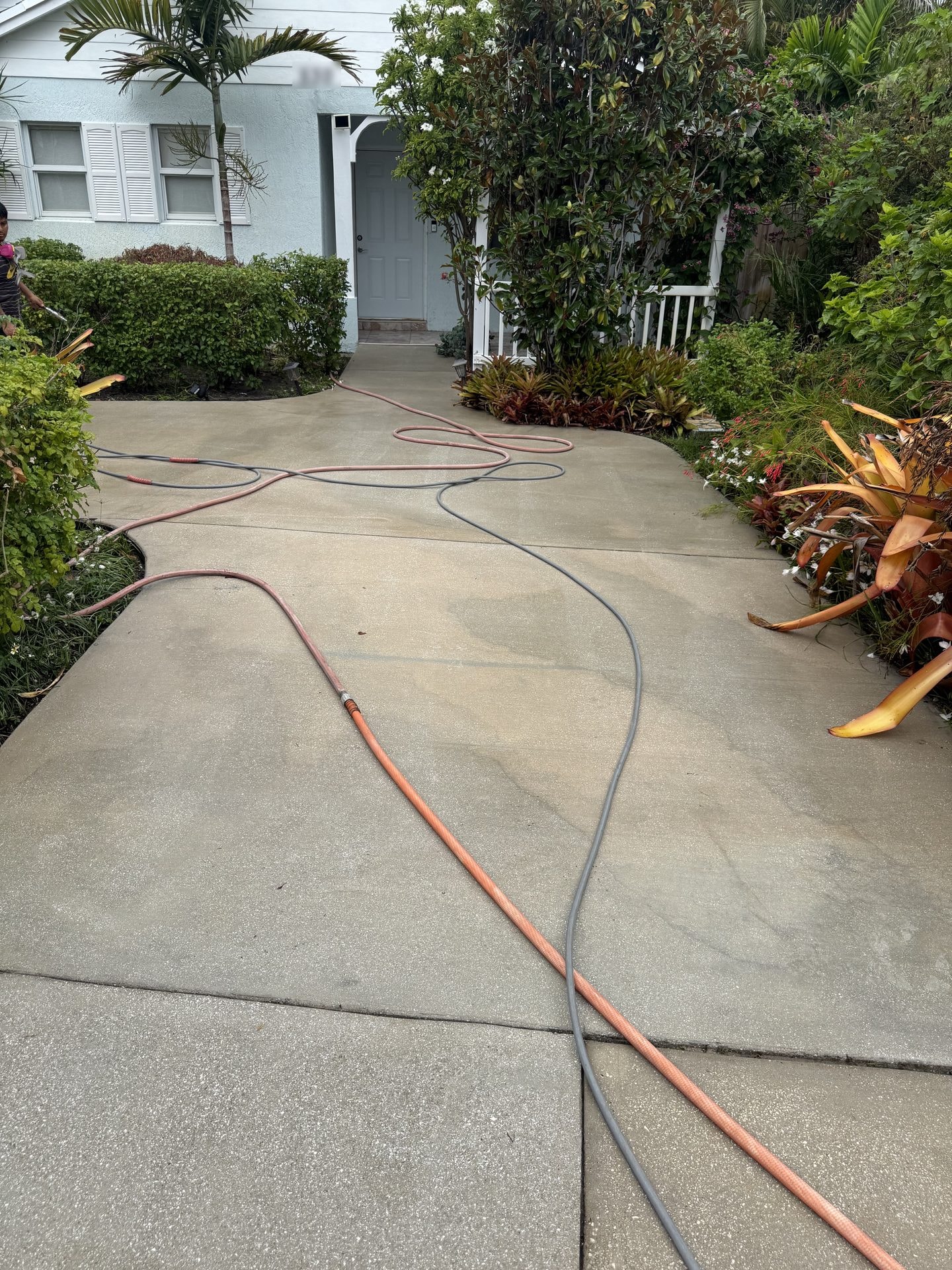 The same Delray Beach, FL concrete driveway after cleaning