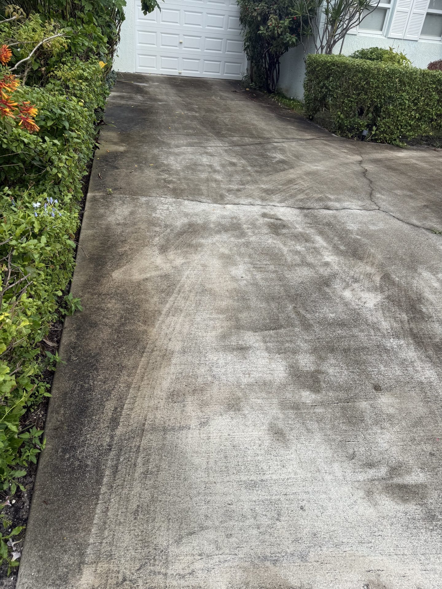 Concrete driveway in Delray Beach, FL before cleaning