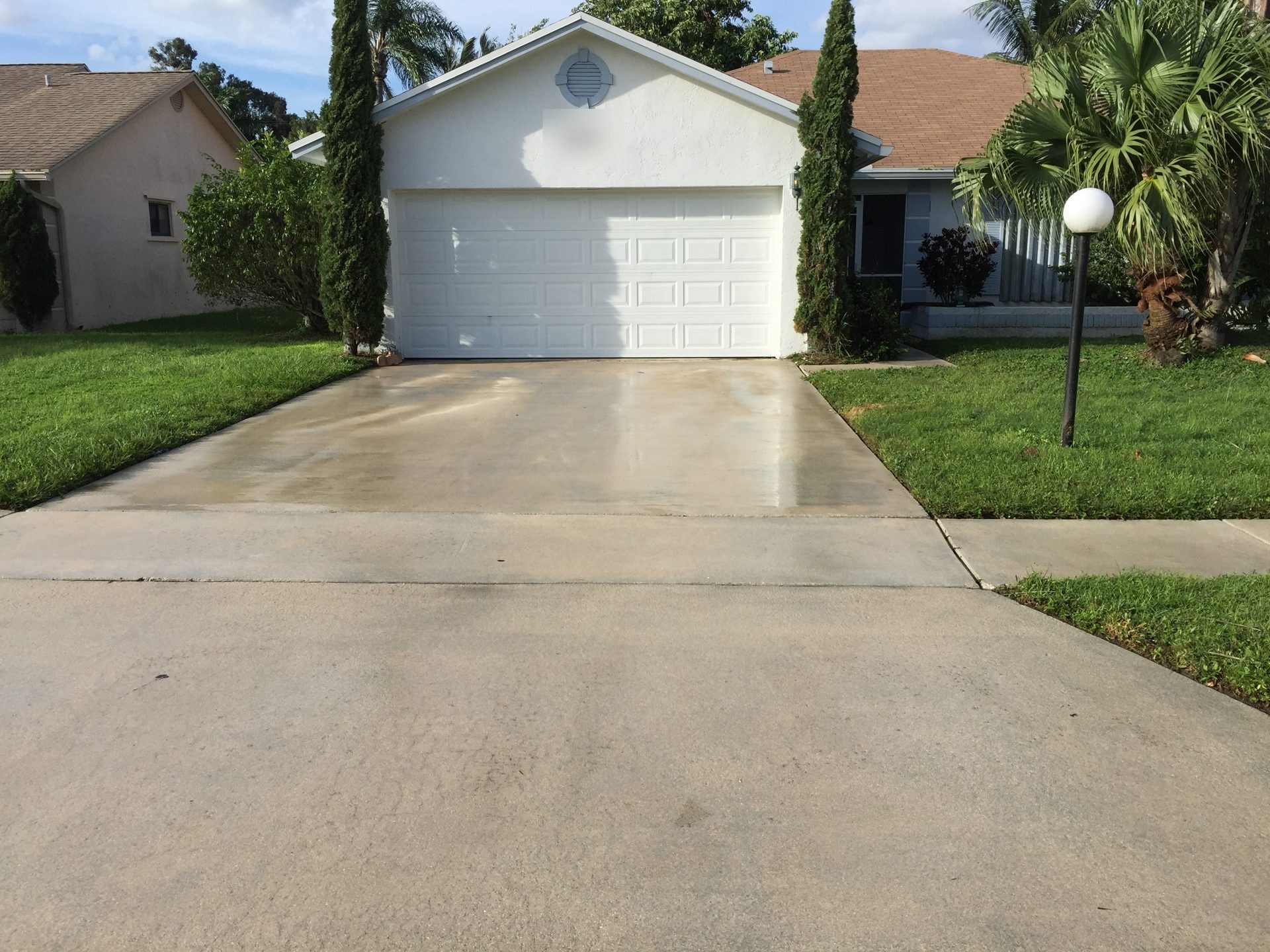 The same concrete driveway after pressure cleaning, Greenacres, FL