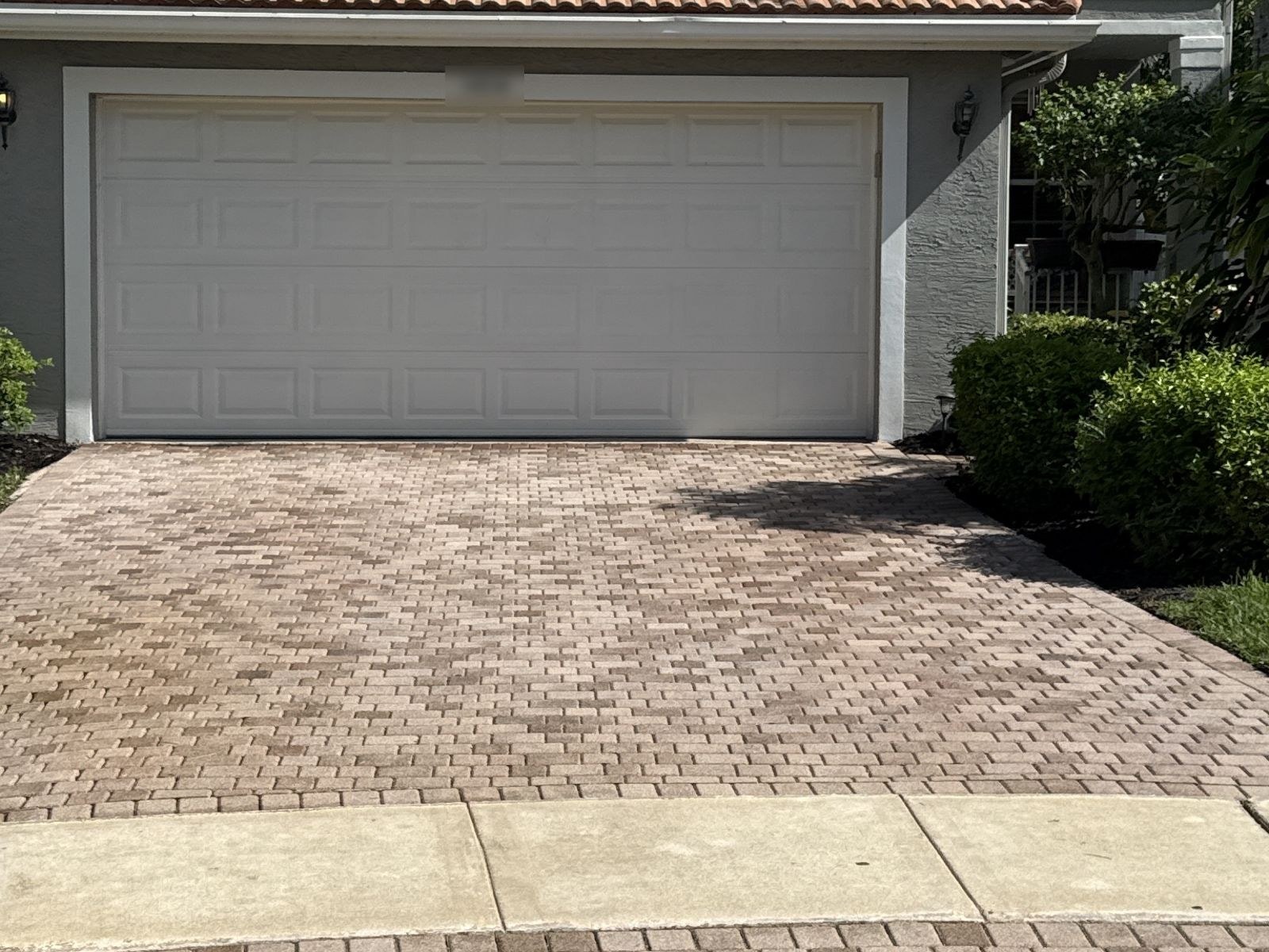 After: The same brick paver driveway after cleaning with uniform restored paver color, Greenacres, FL