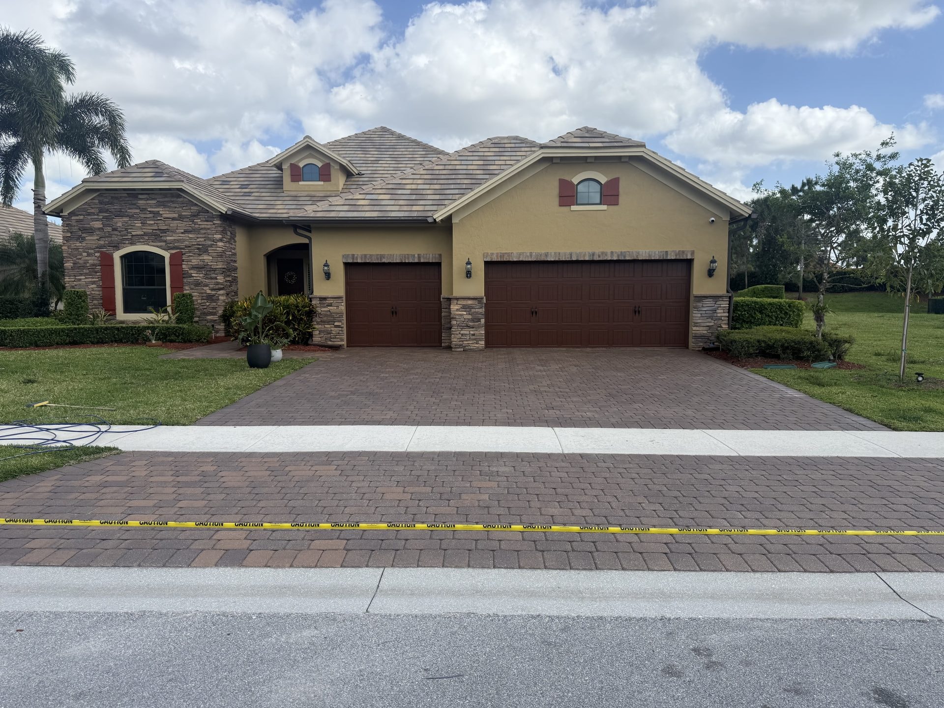 After: Brick paver driveway after cleaning and sealing with paver color restored and deepened, Wellington, FL