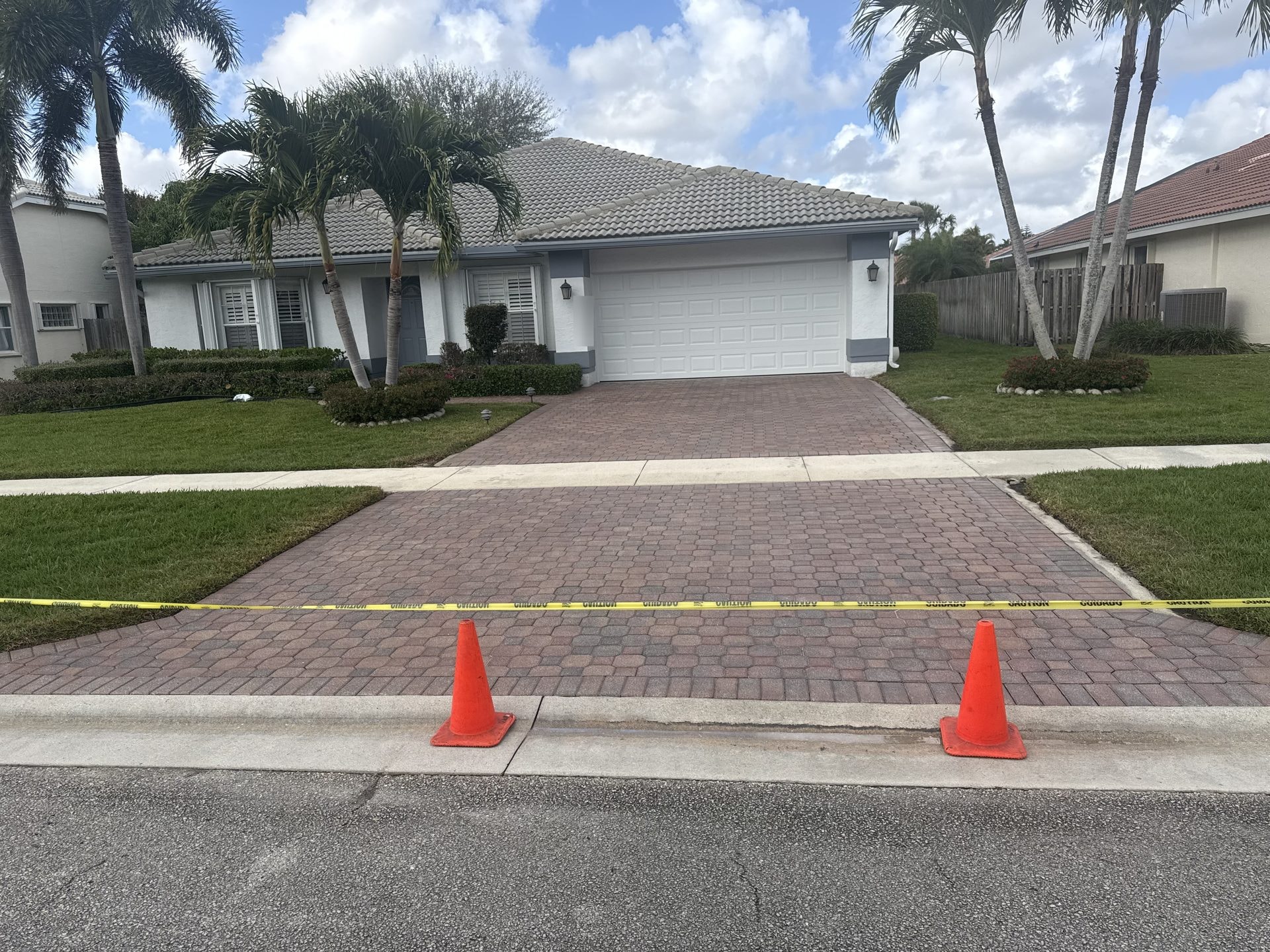 After: Brick paver driveway after pressure washing with clean uniform paver color restored, Lake Worth, FL