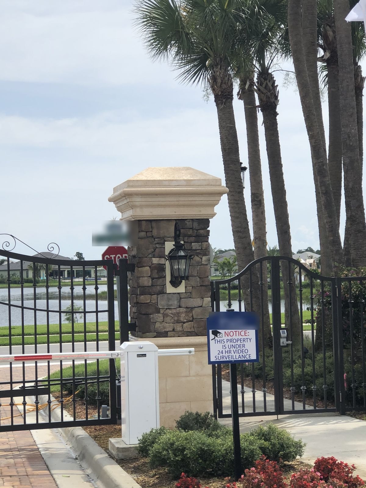 After: Stone entry column with lantern after cleaning, staining removed from cap, gated HOA community, Jupiter, FL