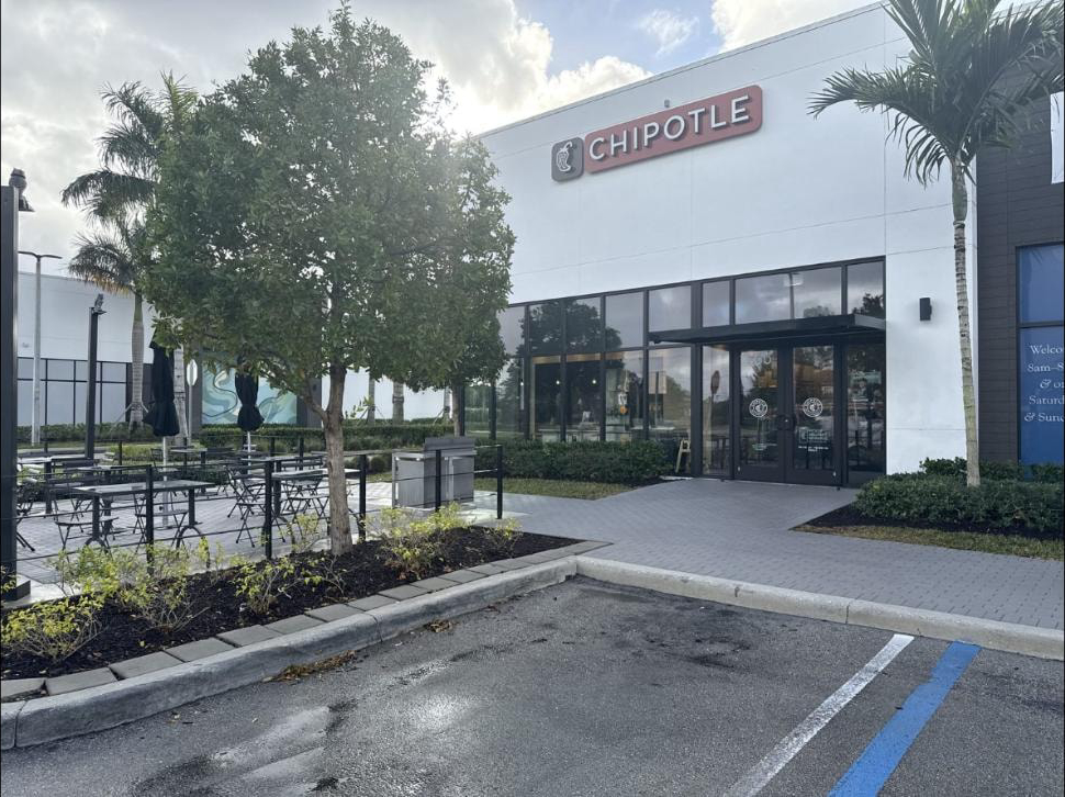 After: Restaurant patio and entrance in Lake Worth, FL after pressure washing — clean pavers, patio furniture back in place