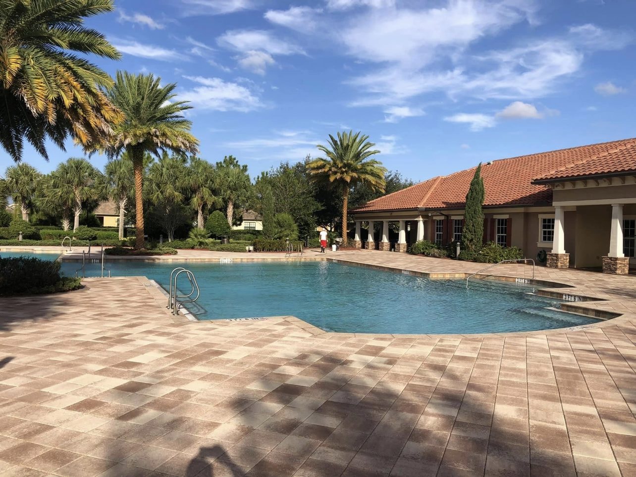 After: The same HOA community pool deck after cleaning and sealing with the paver color restored, Wellington, FL