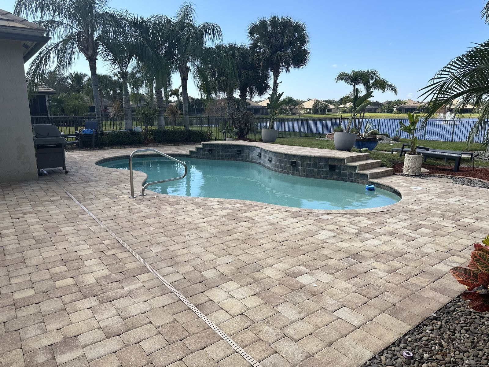 After: Paver pool deck after pressure washing with clean uniform surface, Wellington, FL