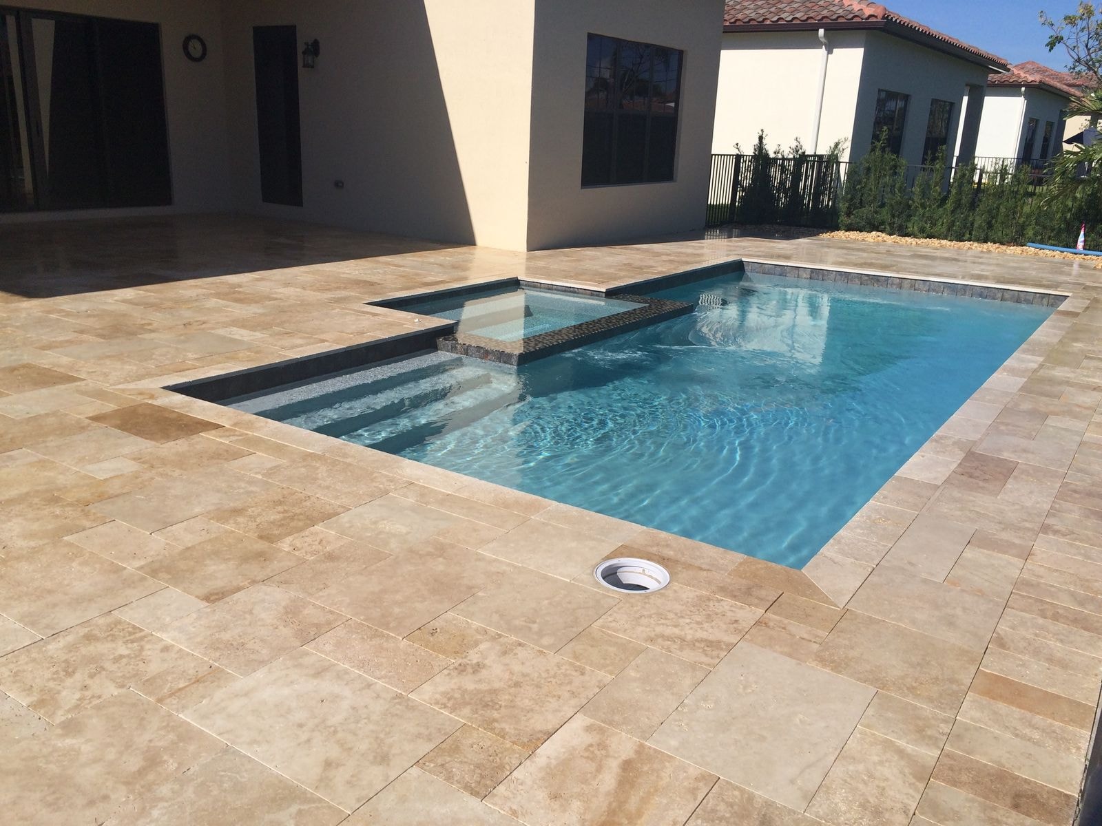 After: Travertine pool deck after cleaning and sealing with the stone color restored and deepened, Wellington, FL