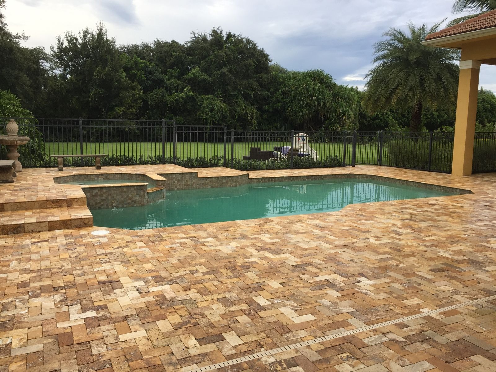 After: Travertine pool deck after cleaning with restored stone color, Palm Beach Gardens, FL