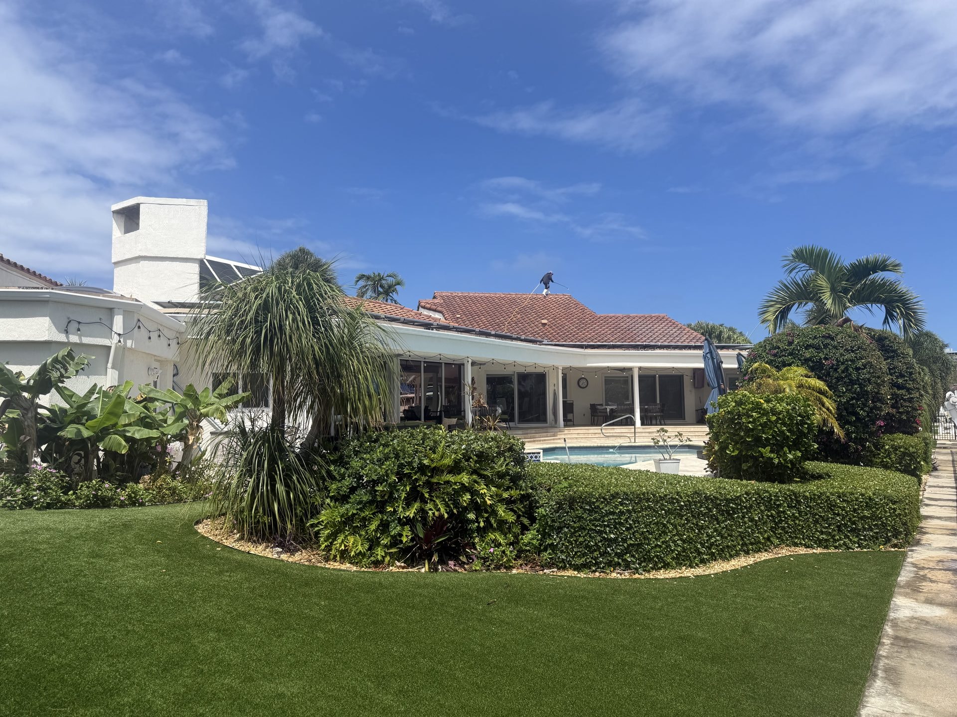 Barrel tile roof after soft-wash cleaning with the terracotta color restored, Boca Raton, FL