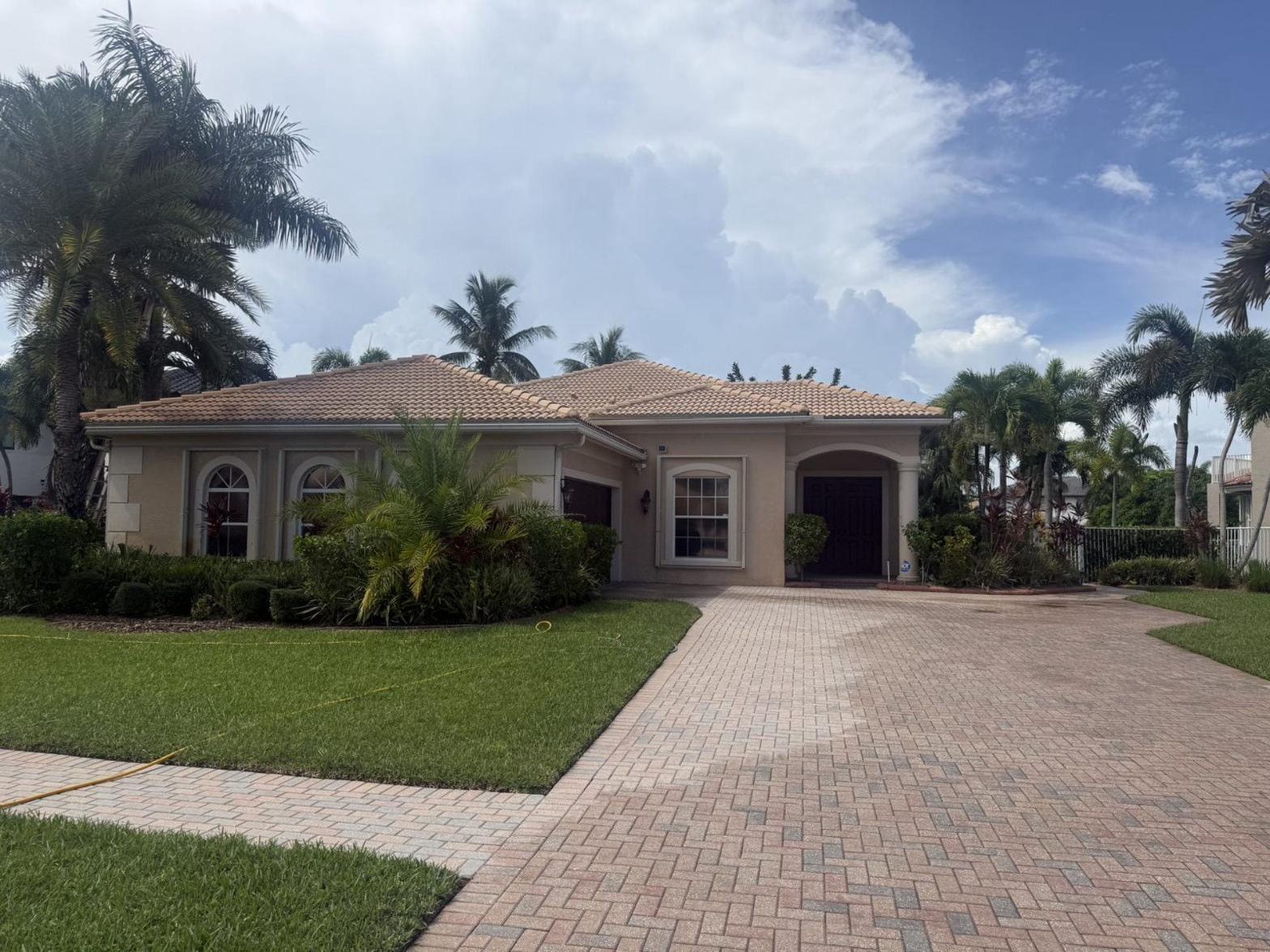 After: The same Royal Palm Beach, FL roof and paver driveway after cleaning