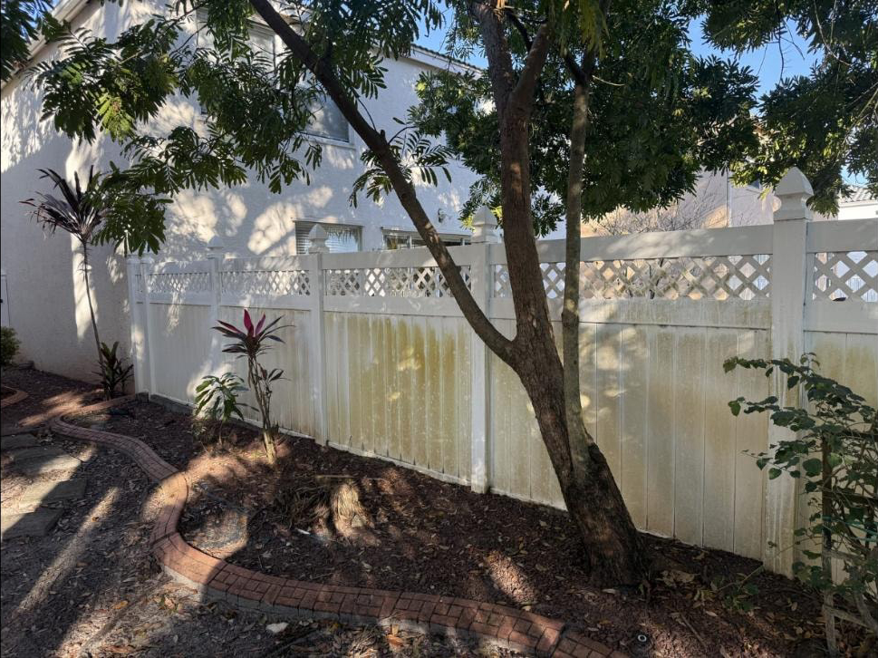 Before: Vinyl fence in Royal Palm Beach, FL heavily soiled with mold and mildew before soft-wash cleaning