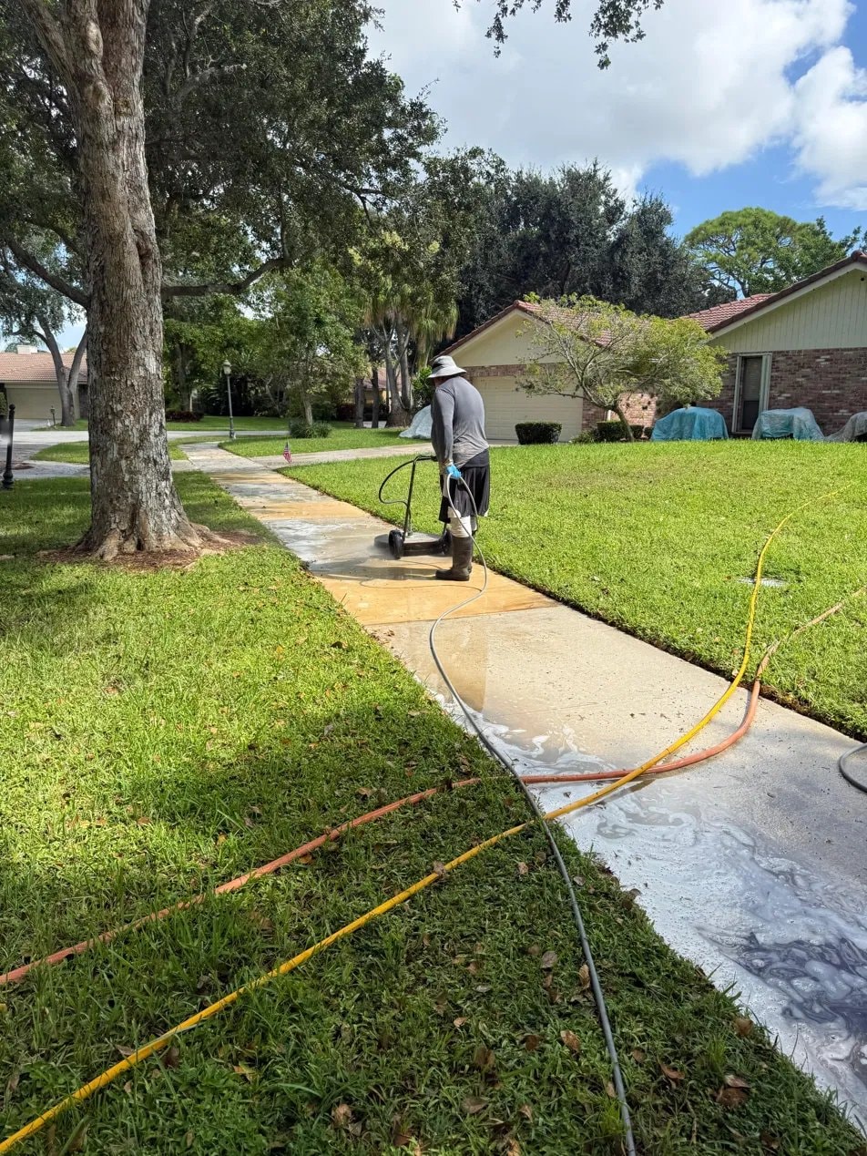 Concrete sidewalk pressure washing in progress - Boca Raton, FL
