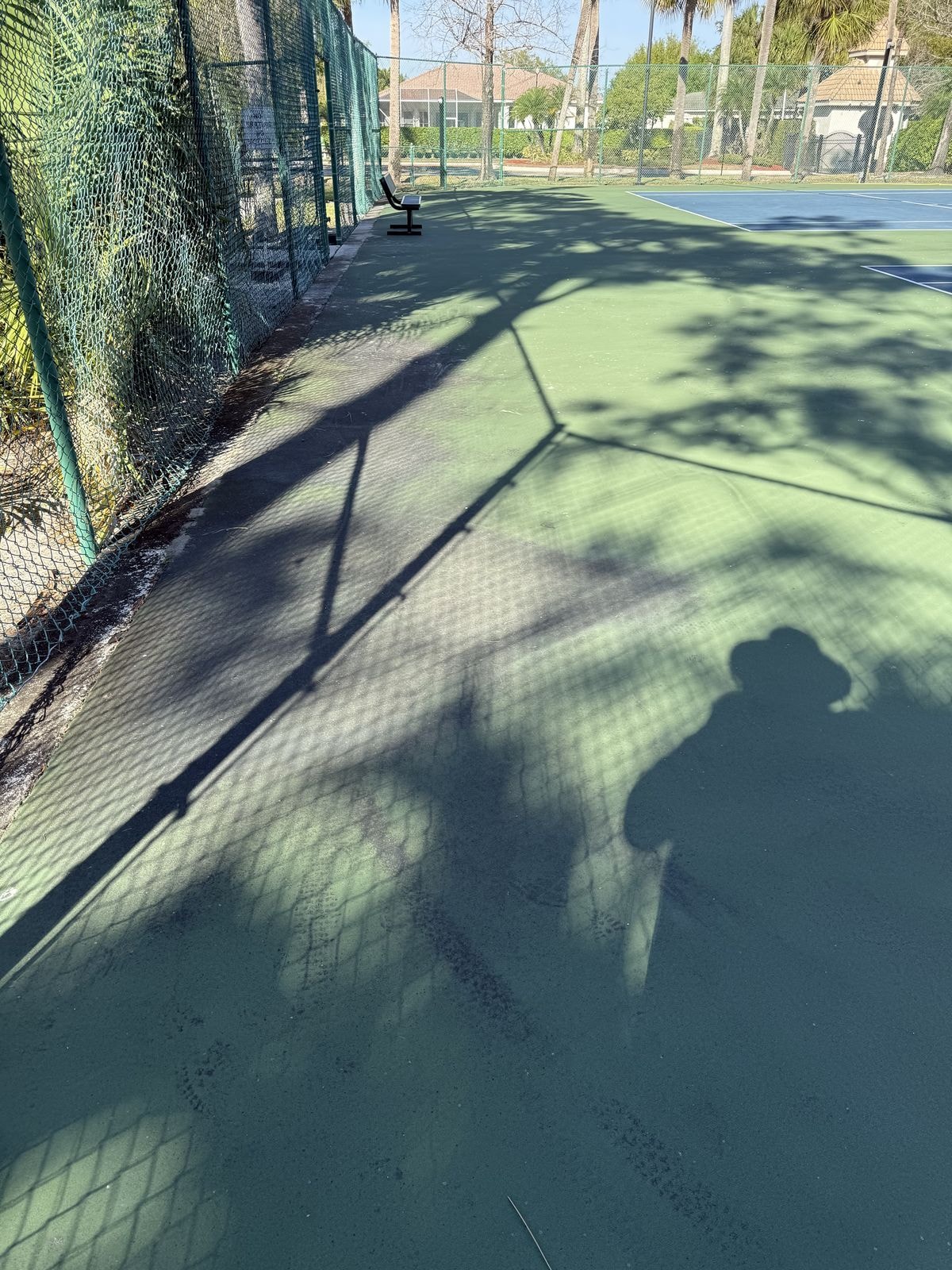 Tennis court before soft-wash cleaning treatment in Lake Worth, Florida