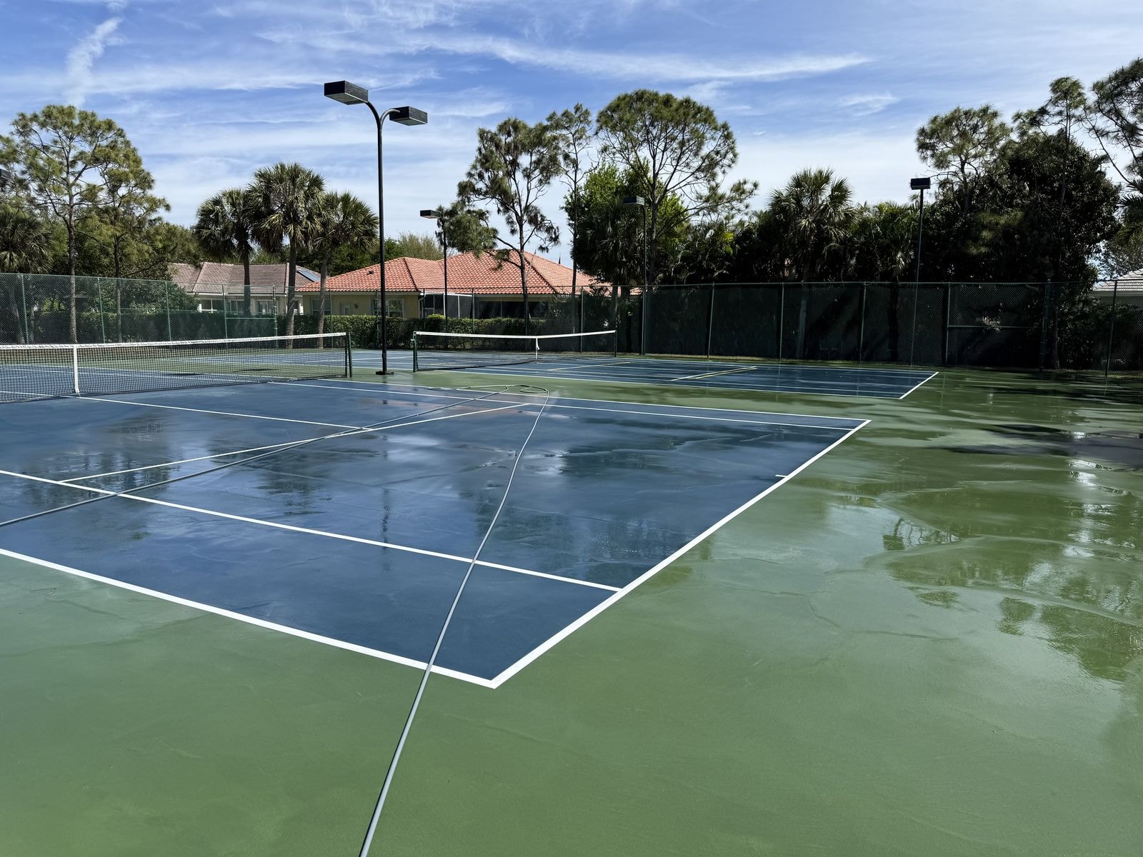 Sports court restored with clean surface and bright lines after soft-wash cleaning in Lake Worth, Florida