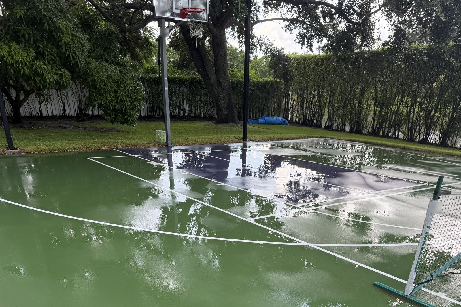 The same Davie, FL pickleball and basketball court after soft washing, with clean green acrylic and bright white playing lines