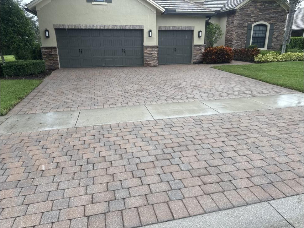 Brick paver driveway pressure washing at a Wellington, FL home — three-car garage, clean pavers