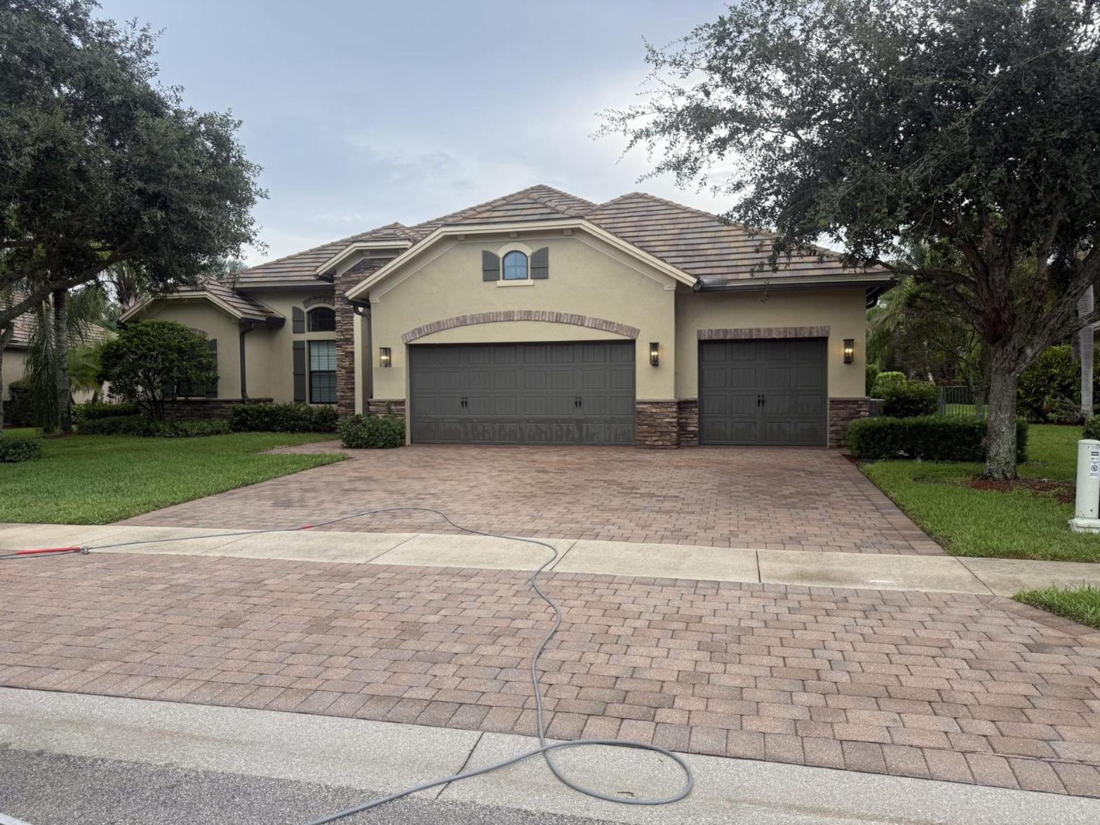 After: The same Wellington, FL brick paver driveway after pressure washing