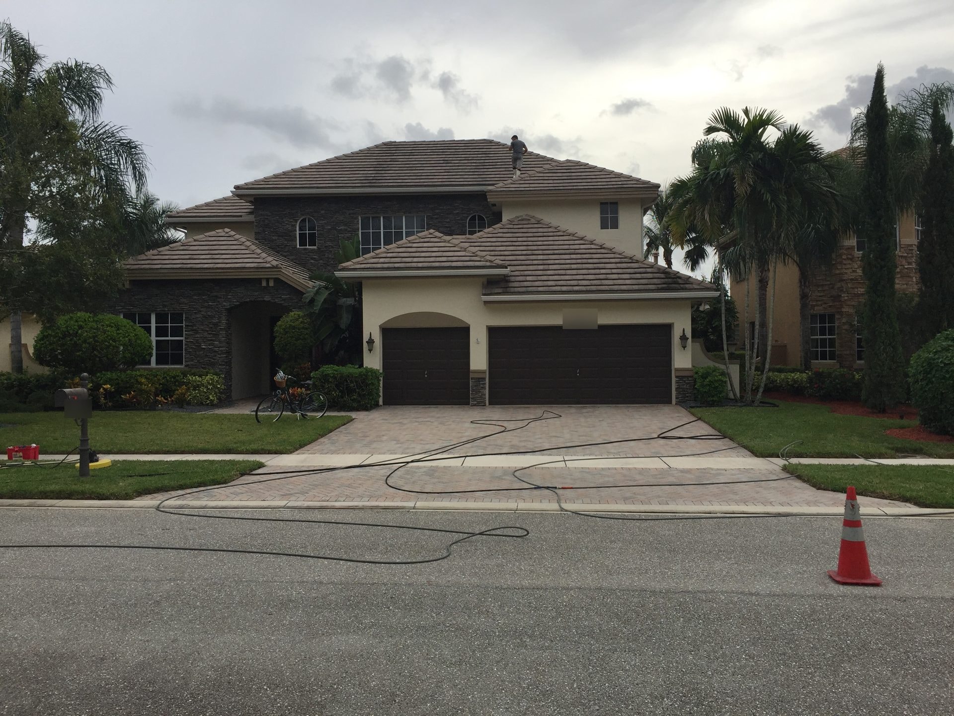 Two-story Wellington, FL home with a dulled, darkened tile roof before soft washing