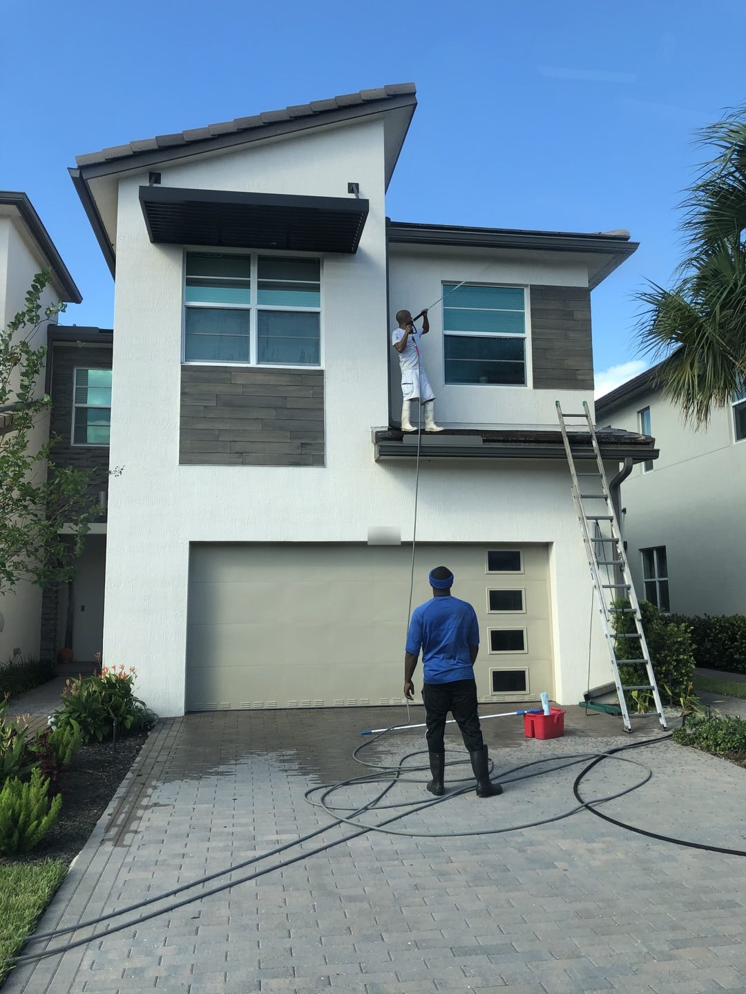 Window washing on a two-story home, Greenacres, FL