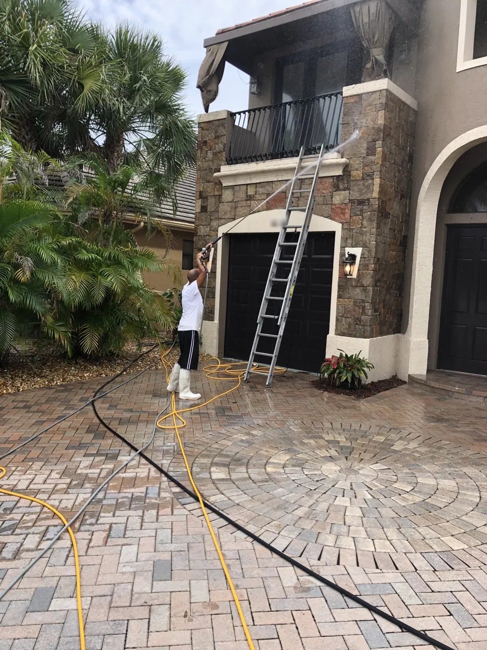 Two-story stone entry and balcony after soft washing in Wellington, FL